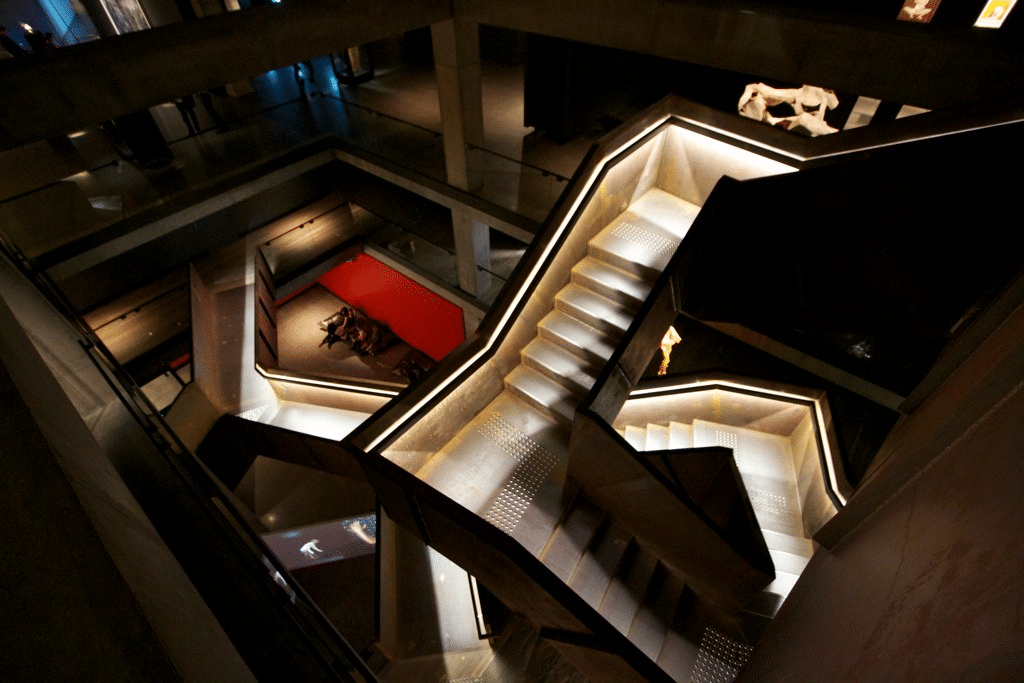 A beautifully lit staircase in a Hobart building at night