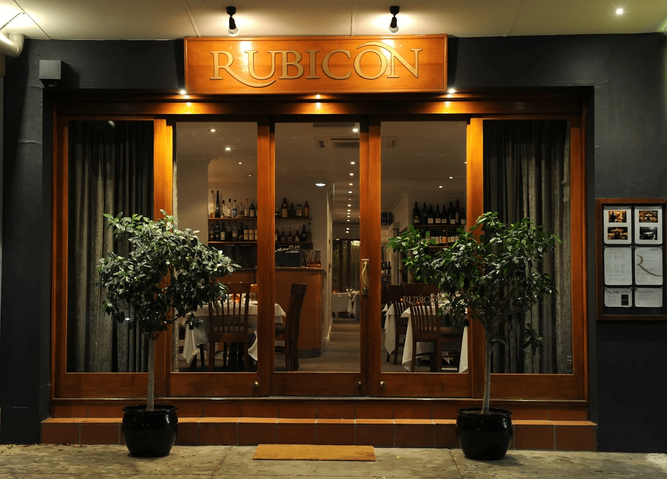 A restaurant entrance with potted plants in Canberra