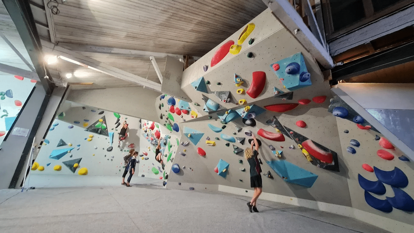 Couple standing in front of rock climbing wall in Hobart group activities blog