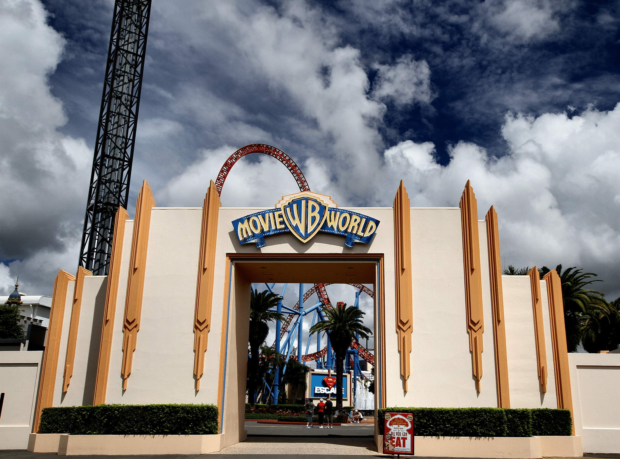 Entrance to movie world theme park with roller coaster
