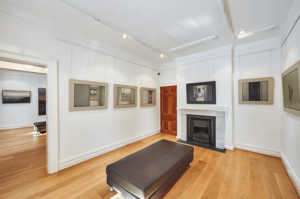 Living room with fireplace in Surry Hills home