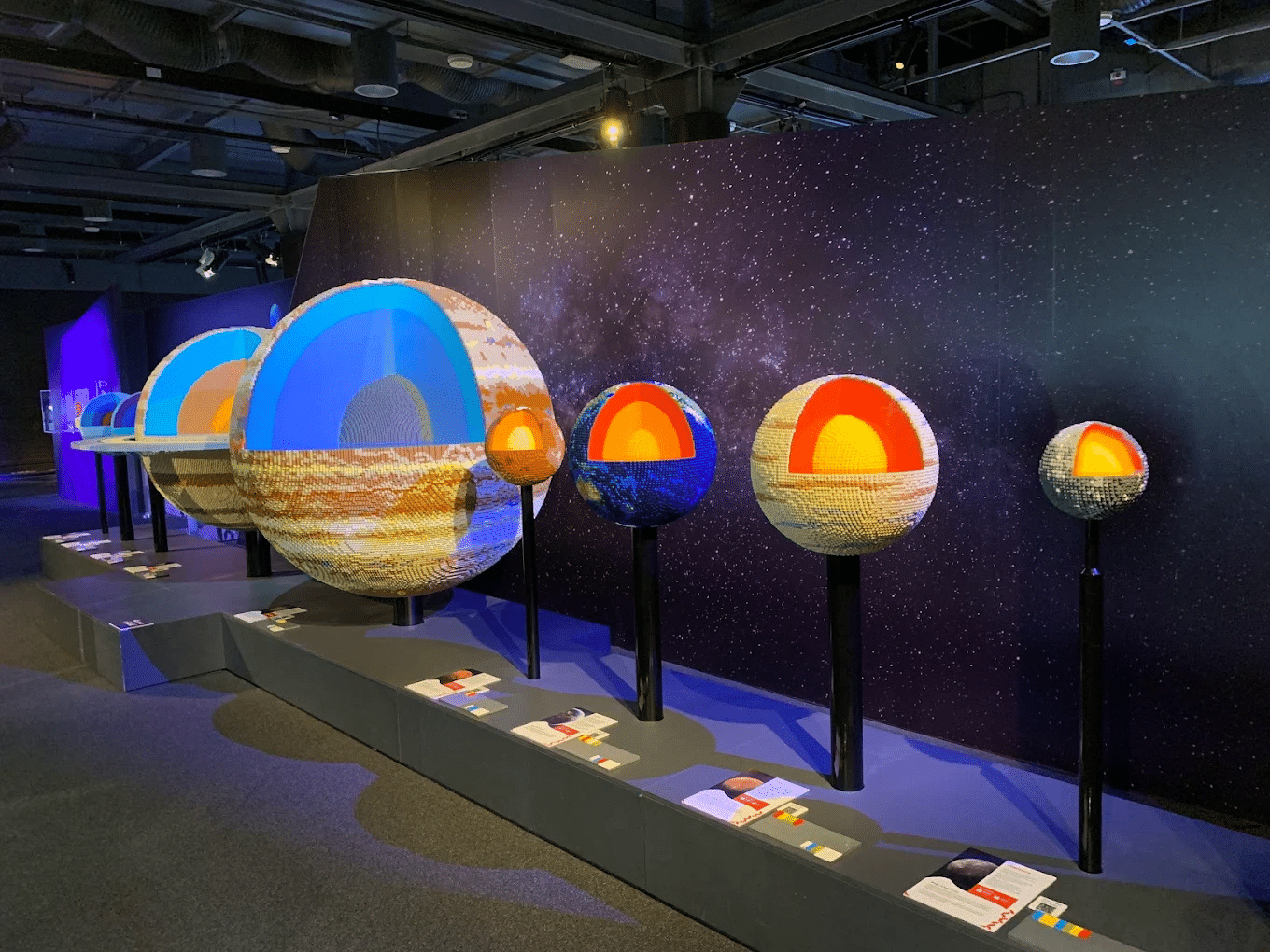 Museum exhibit with various planets on display