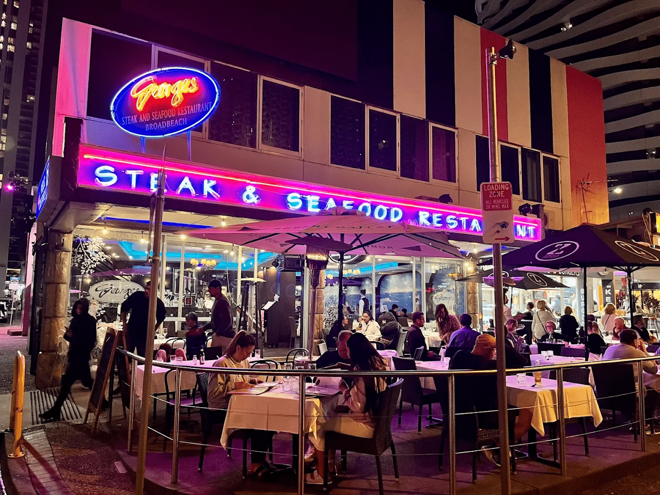 People dining outdoors at a restaurant during Gold Coast food tour