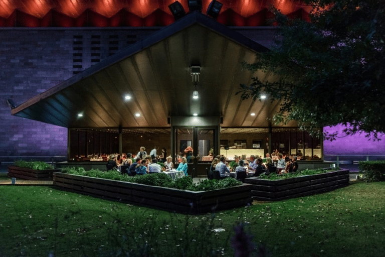 People sitting outside building at night in Port Phillip Melbourne