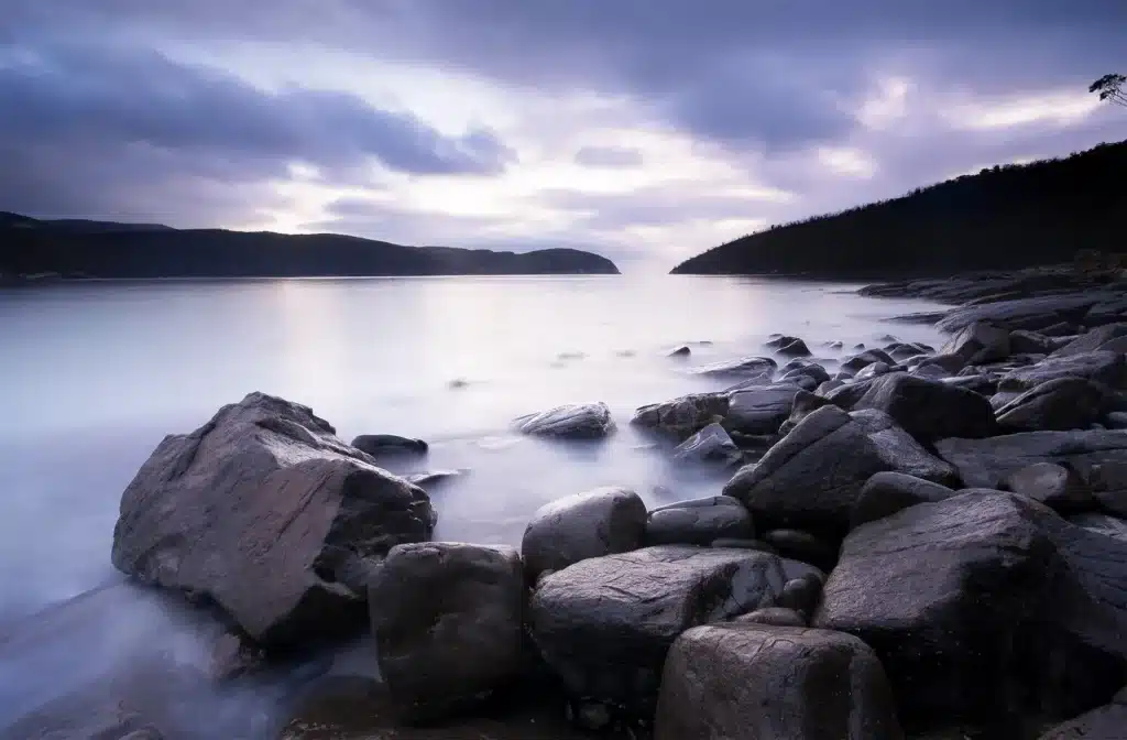 Rocky shore with mountains and water in Hobart Tasmania