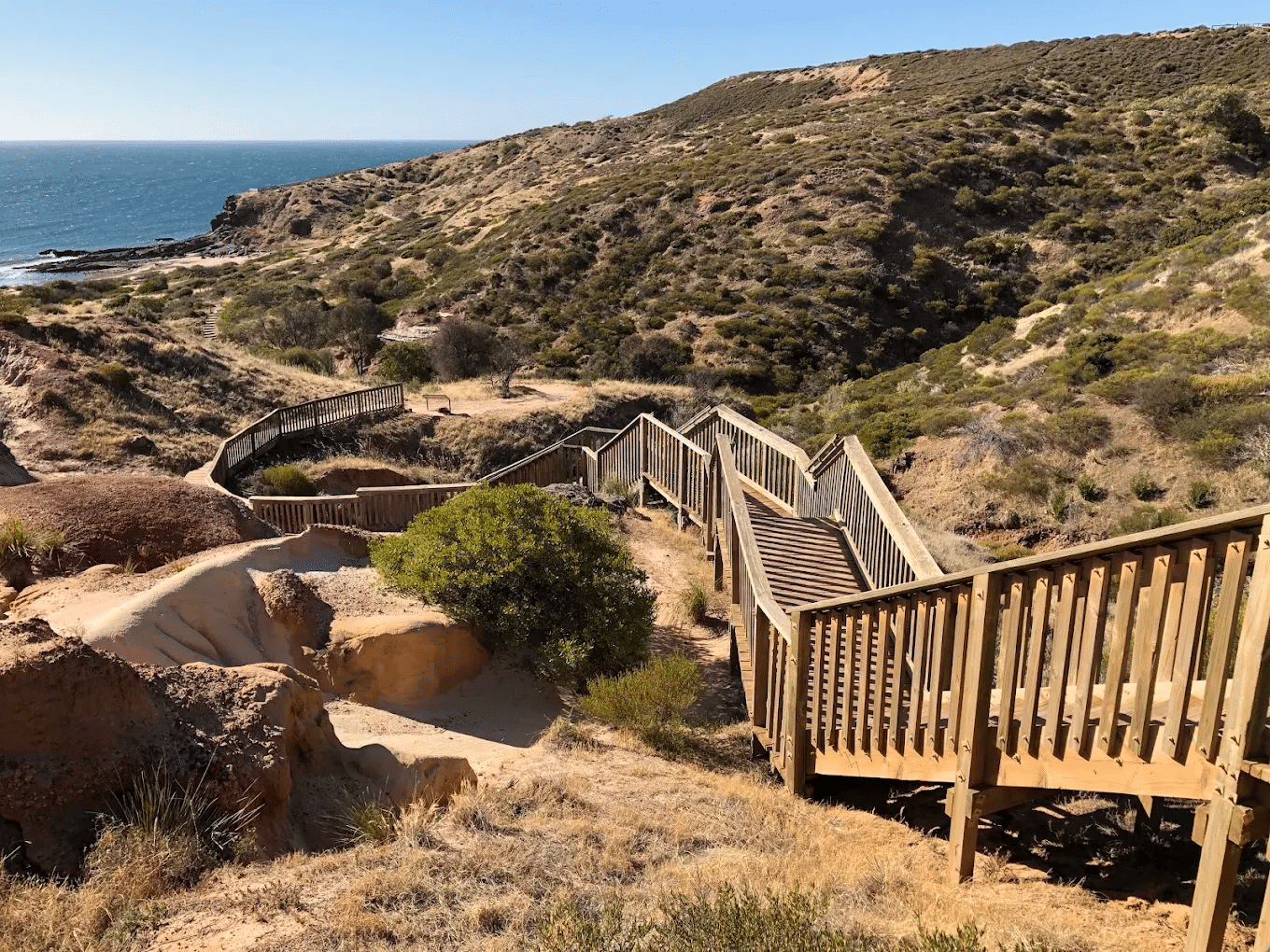 Wooden staircase ascending a hill by the ocean in Adelaide