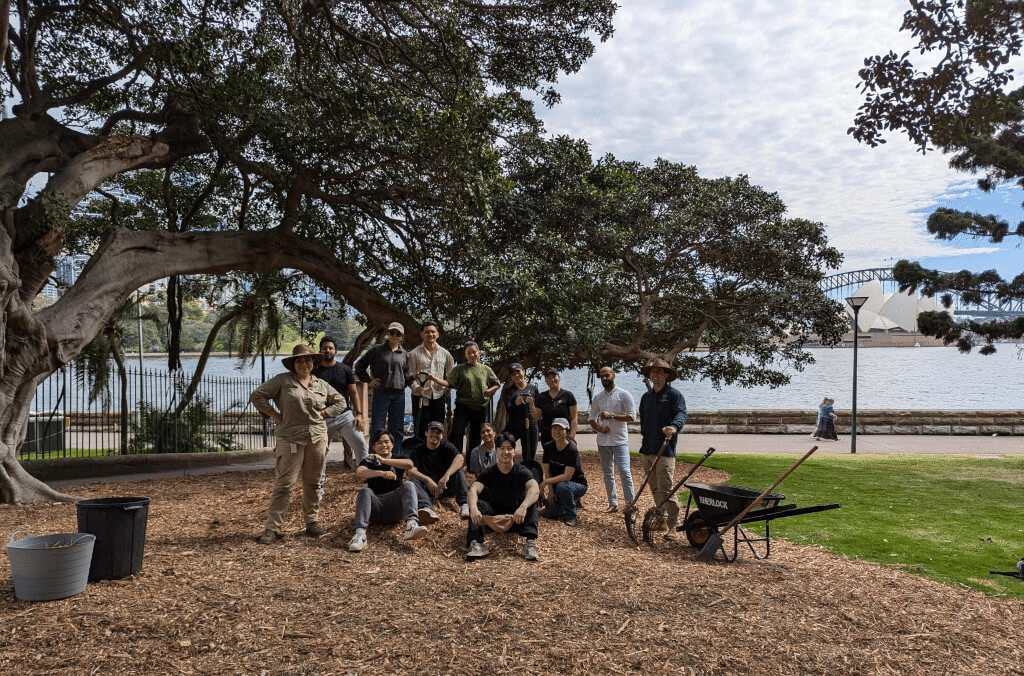 A group of friends standing together under a tree in Sydney