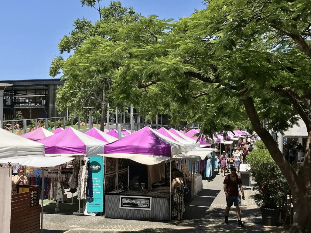 A group walking near tents in Brisbane music venue area