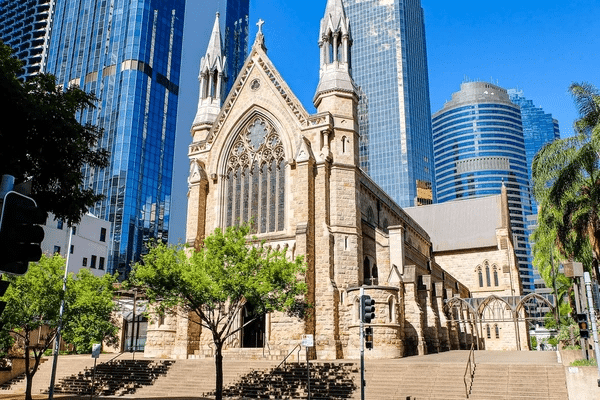 A large church with steeple amid Brisbane cityscape