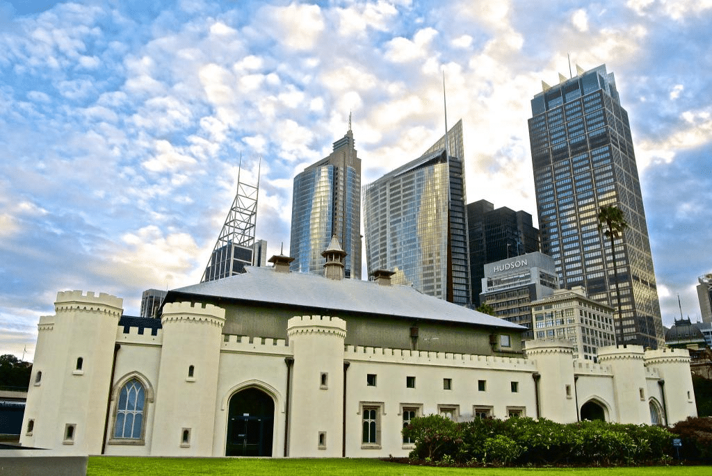 A large white music venue building in Sydney with skyscrapers in the background