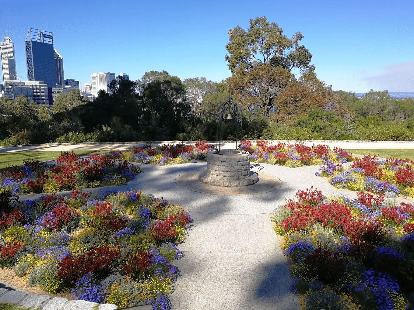 A park fountain surrounded by colorful flowers in Perth