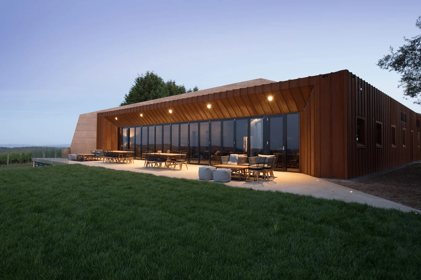 A quaint house with a wooden roof in a lush green field in Launceston