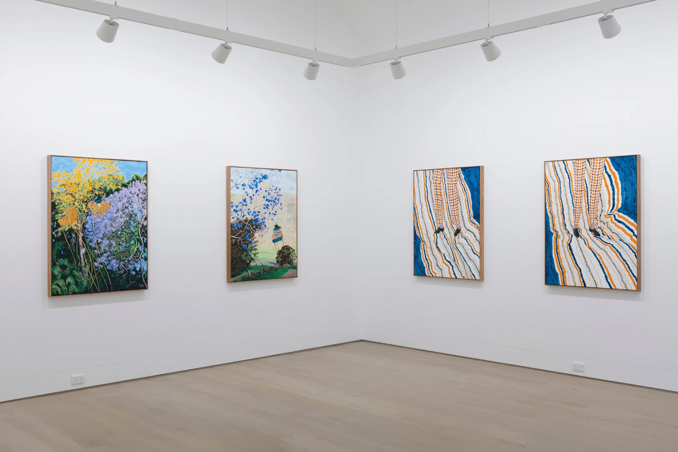A room with three paintings in a Brisbane art gallery