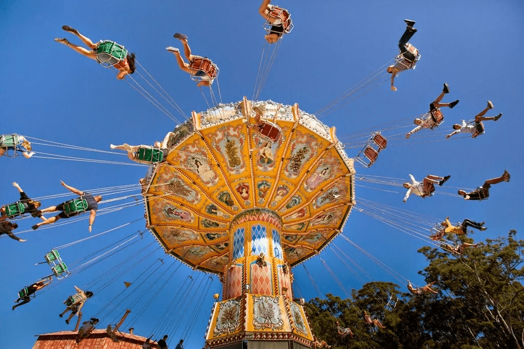 A thrilling carnival ride at Sunshine Coast with people enjoying