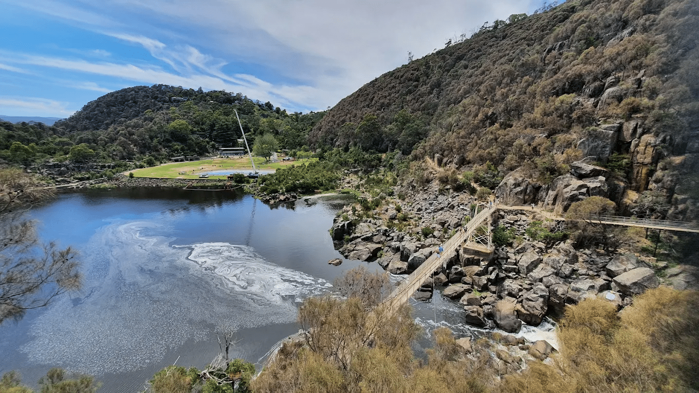 A tranquil lake encircled by majestic mountains on a Launceston day trip