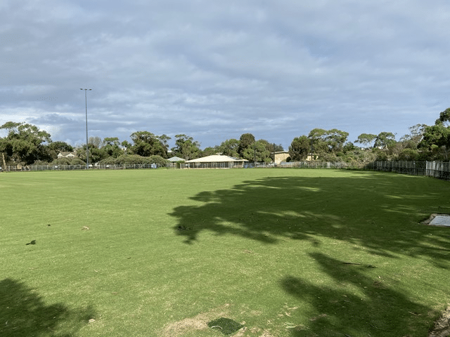 A vast green field with distant trees in Melbourne's Bayside suburbs
