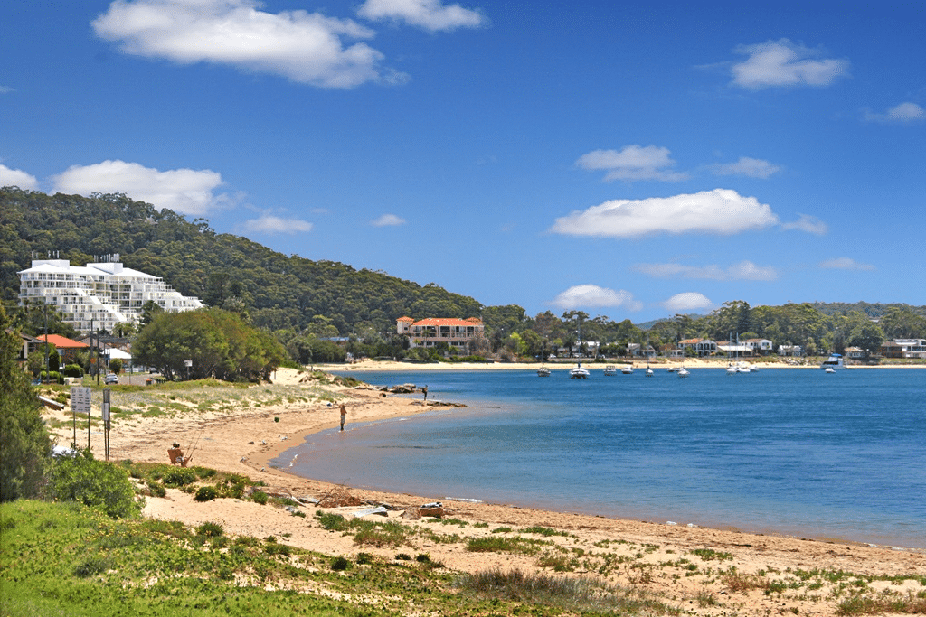 Aerial view of a beach with boats, Central Coast attractions