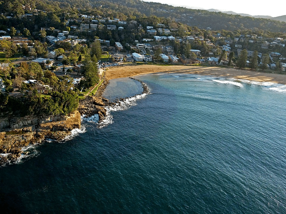 Aerial view of Central Coast beach with homes and ocean
