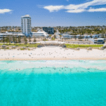 An aerial view of a Perth beach with cityscape in the background