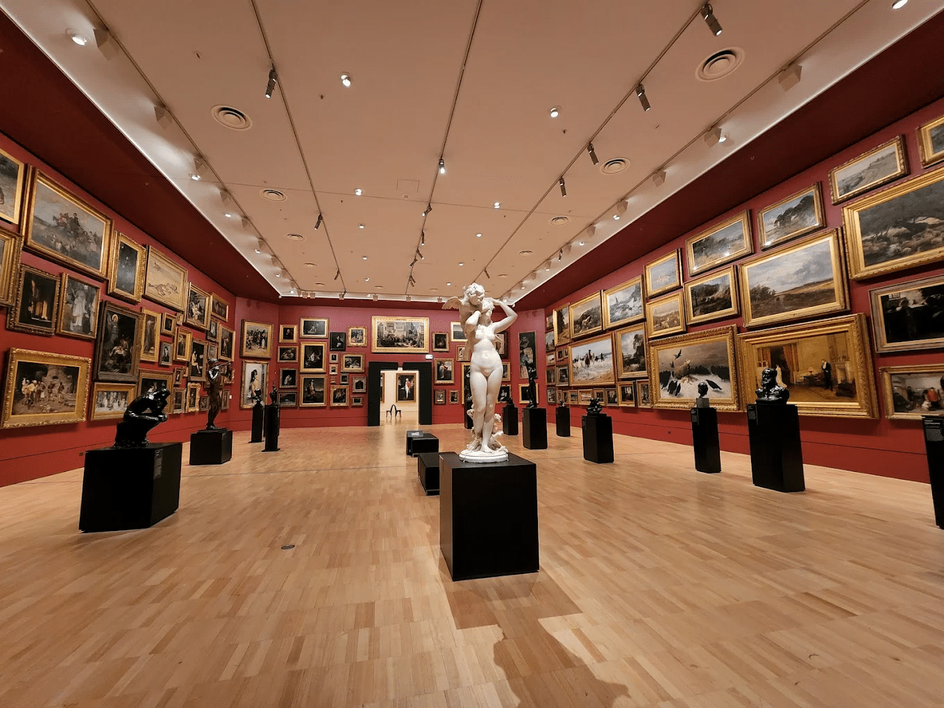 Art-filled room showcasing many paintings and sculptures