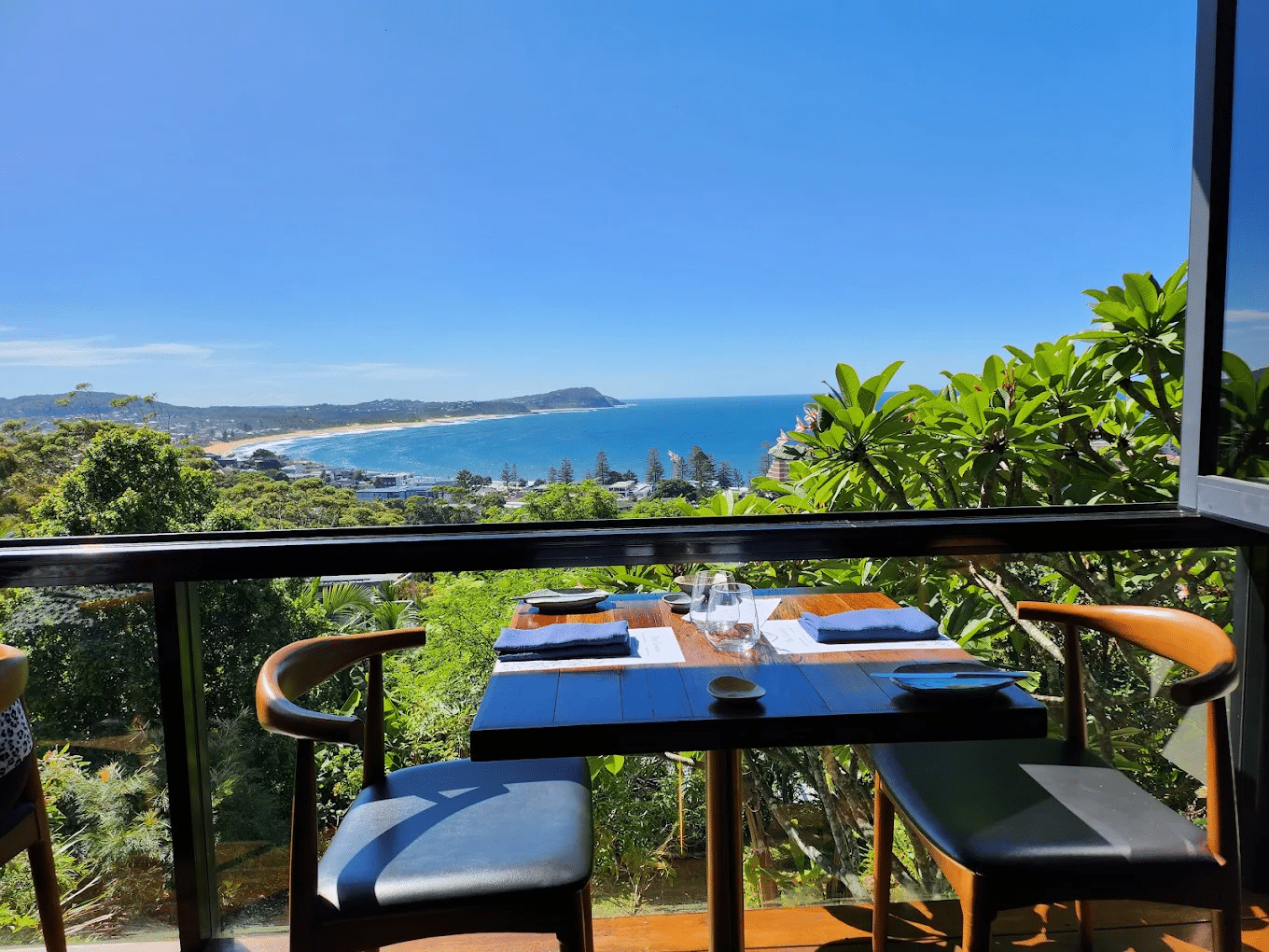 Balcony dining set overlooking the ocean on the Central Coast
