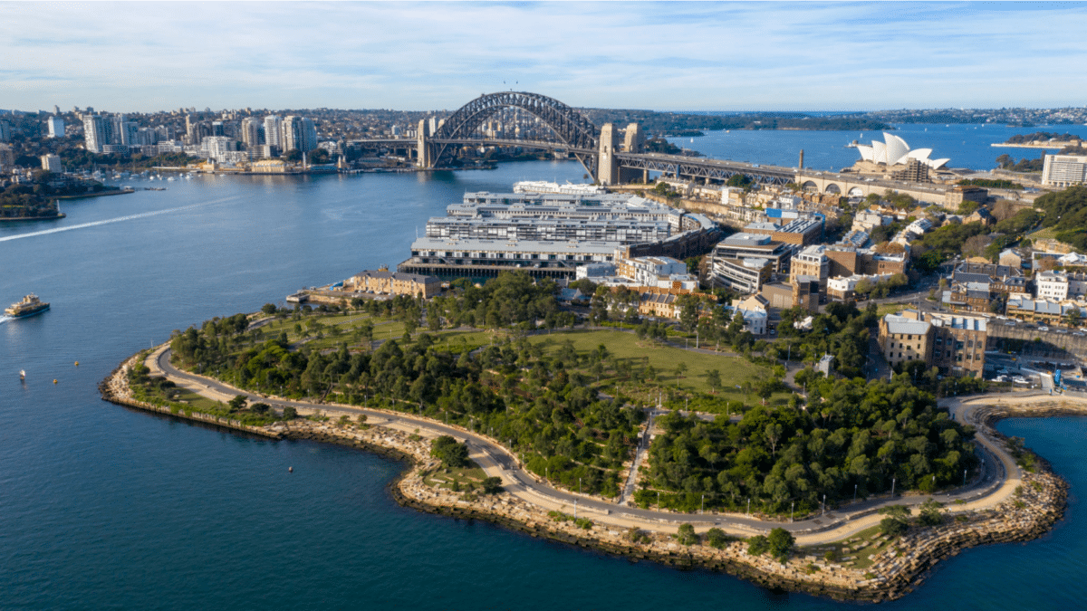 Bird's eye view of Sydney city with iconic bridge in the background