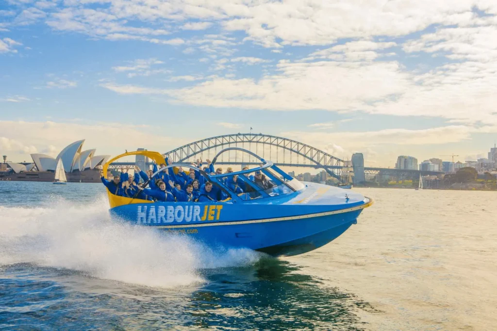 Blue and yellow boat with people enjoying summer in Sydney