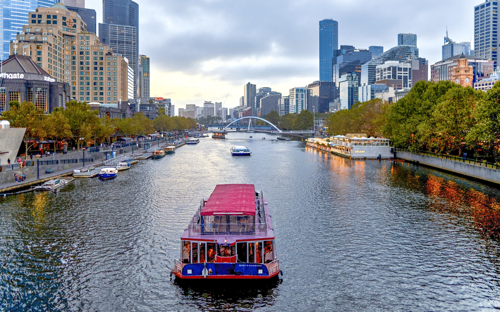 Boat on a river beside skyscrapers in Melbourne