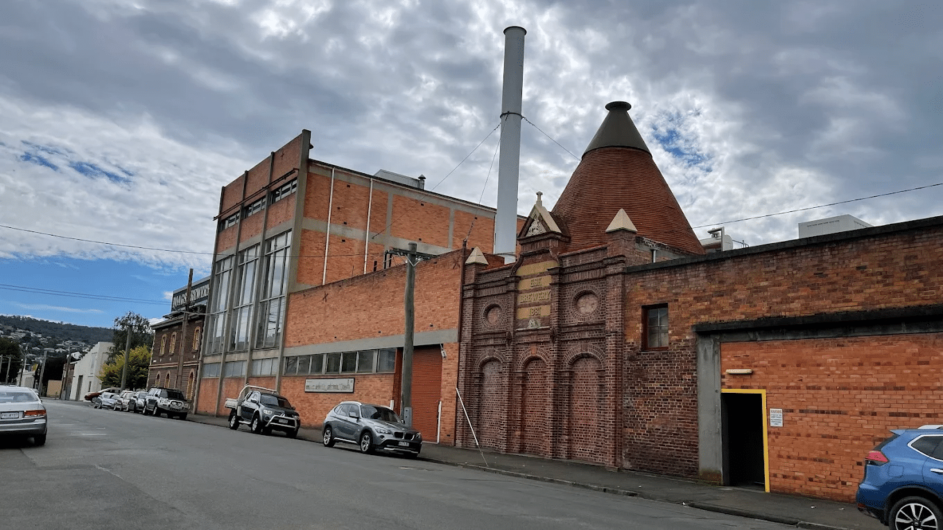 Brick building on Launceston street with parked cars