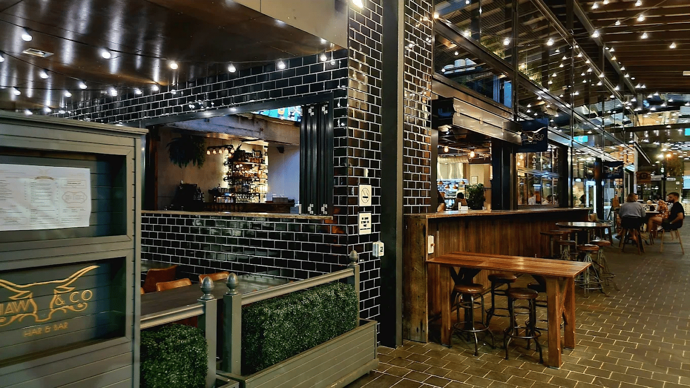 Brick wall restaurant with wooden tables in Townsville