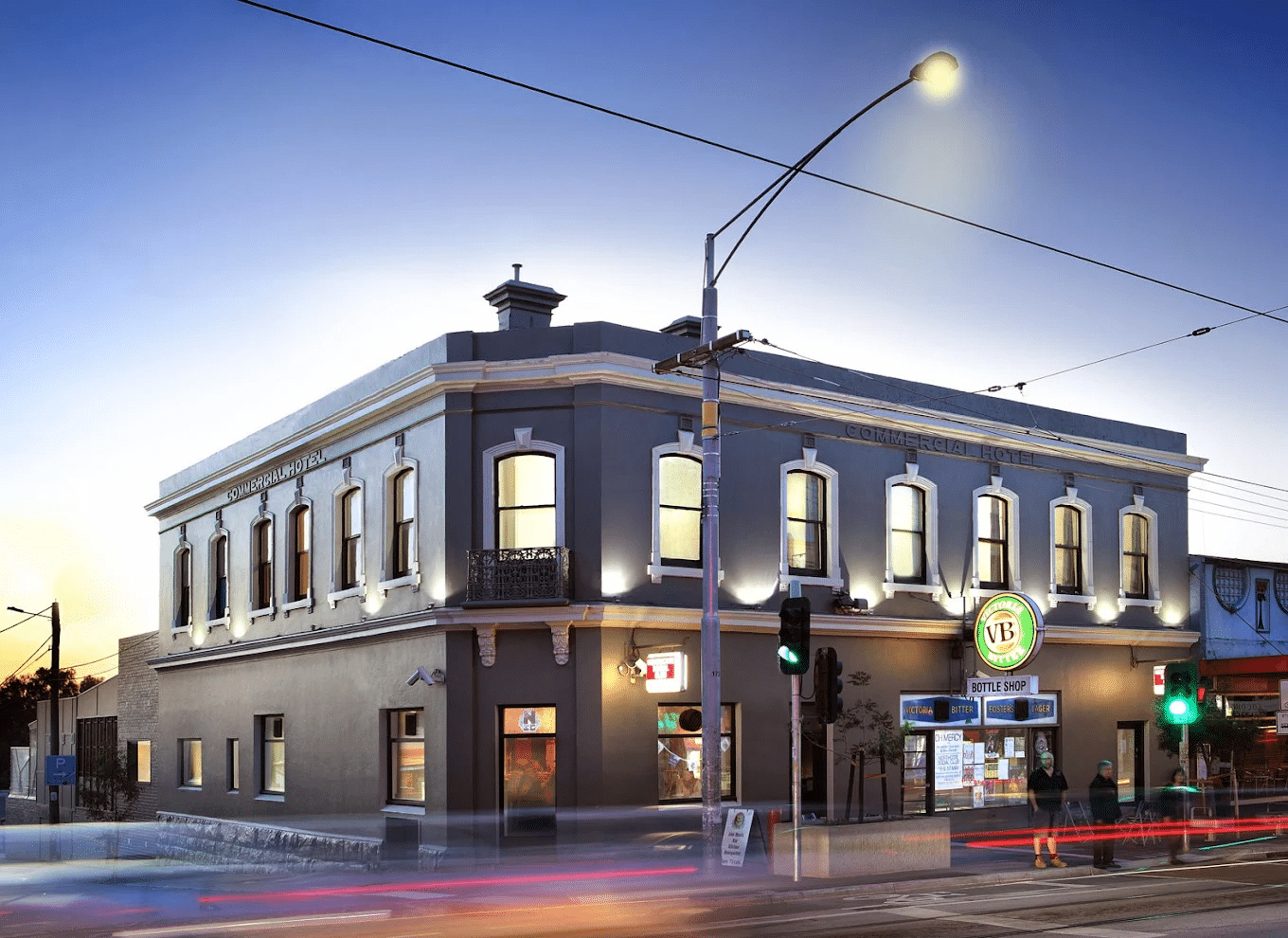 Busy Melbourne street corner with building and traffic lights