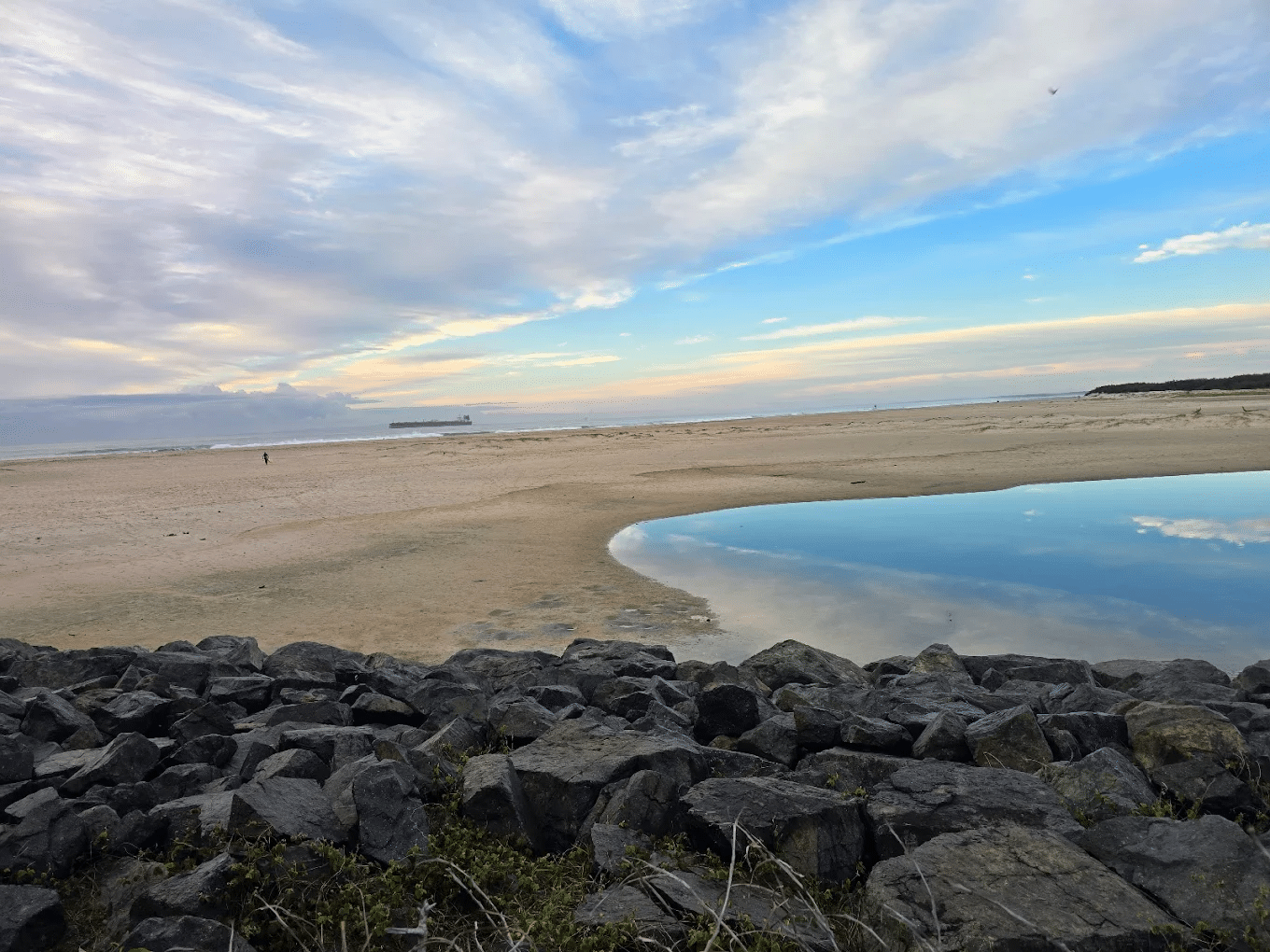 Coastal water view with surrounding rocks and grass in Sunshine Coast