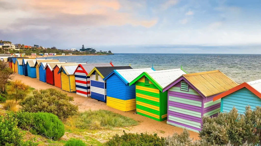 Colorful beach huts by the ocean in Melbourne