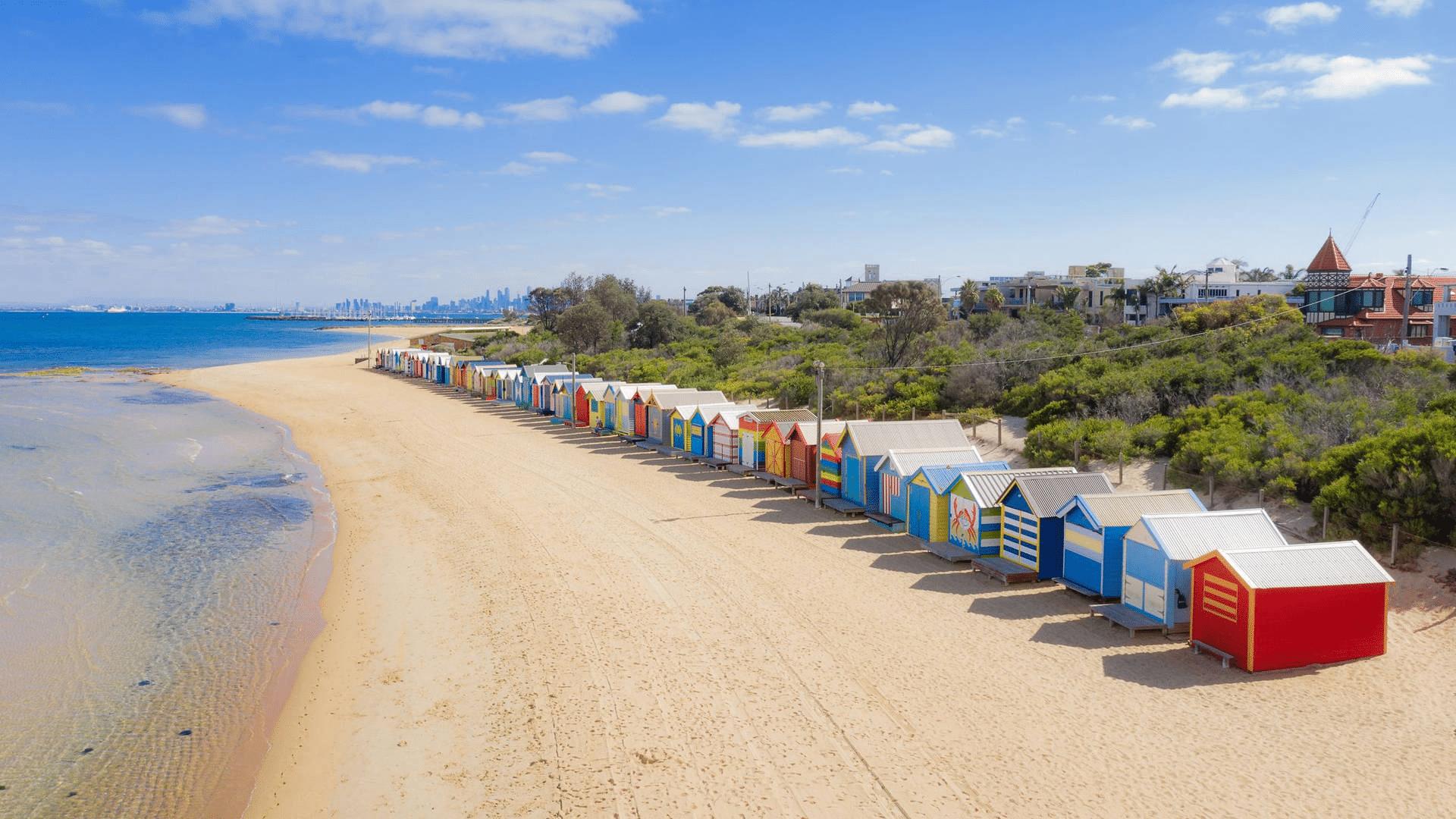Colorful beach huts on a sandy beach in Melbourne