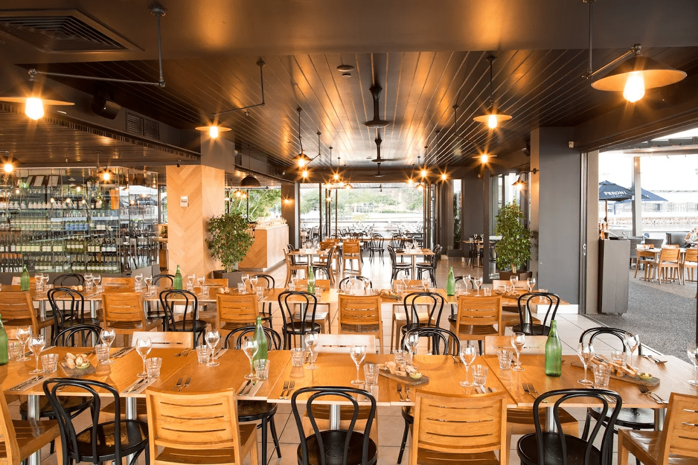 Cozy restaurant interior with wooden tables and chairs in Darwin