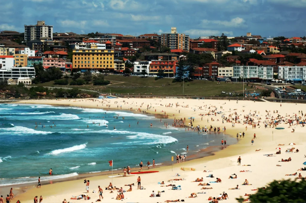 Crowded beach in Sydney with many people enjoying the sun