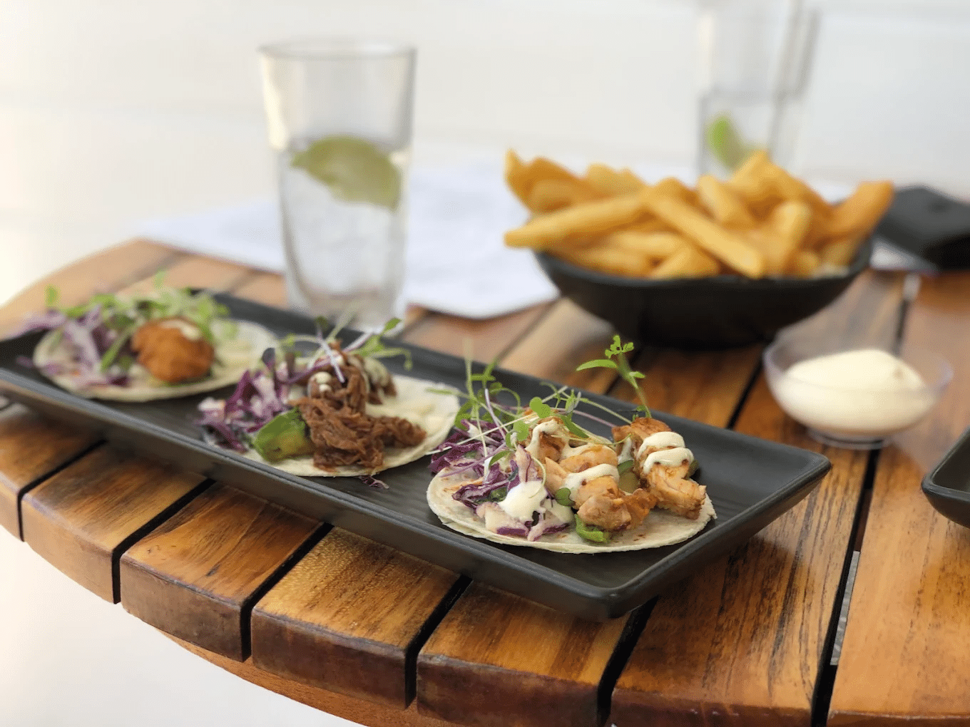 Delicious couple of tacos on black plate during Townsville food tour