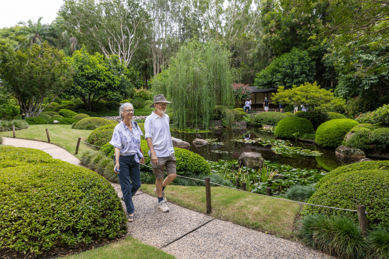 Elderly couple enjoying a garden walk in Brisbane