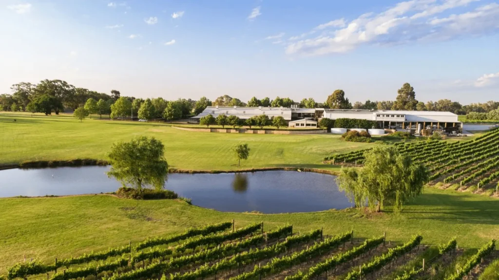 field with pond and winery under clear sky in perth 1