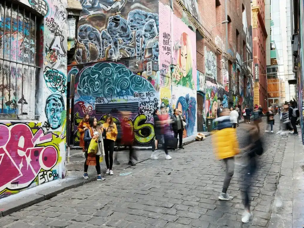 Group of people in front of graffiti-covered building in Melbourne