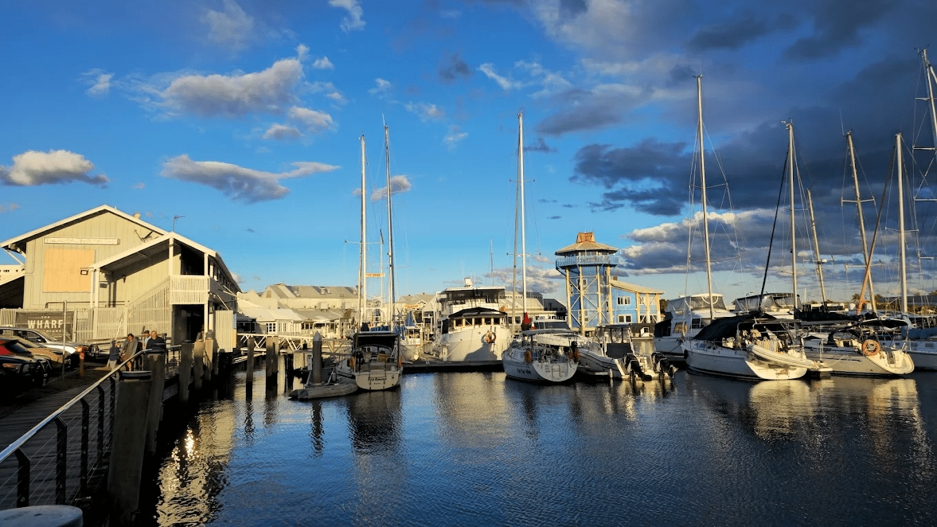 Harbor with numerous boats under cloudy sky at Sunshine Coast