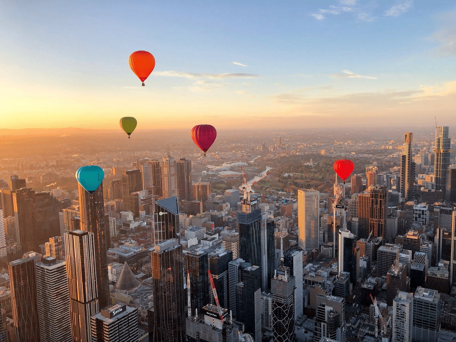 Hot air balloons soaring above Melbourne cityscape