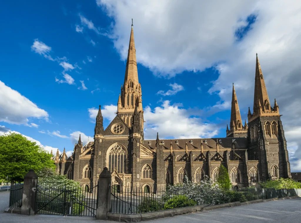 Large church with tall steeple in Melbourne on a cloudy day