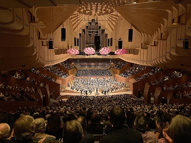 Large concert hall filled with seniors enjoying a day out in Sydney