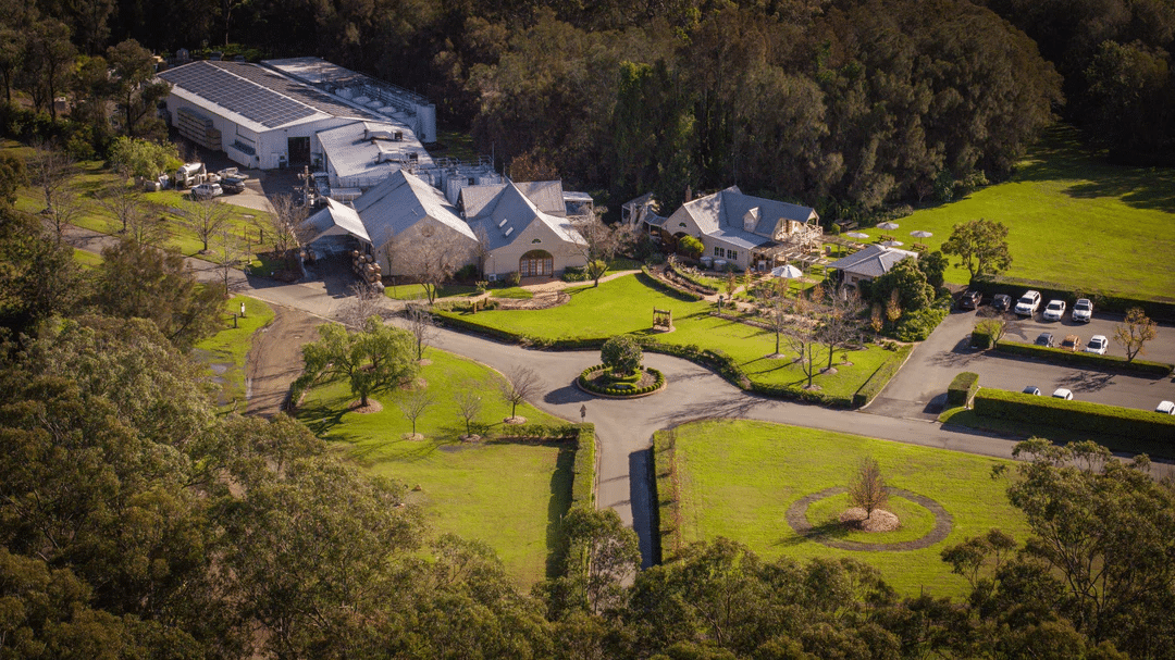 Large home surrounded by trees aerial view at Pepper Tree Wine