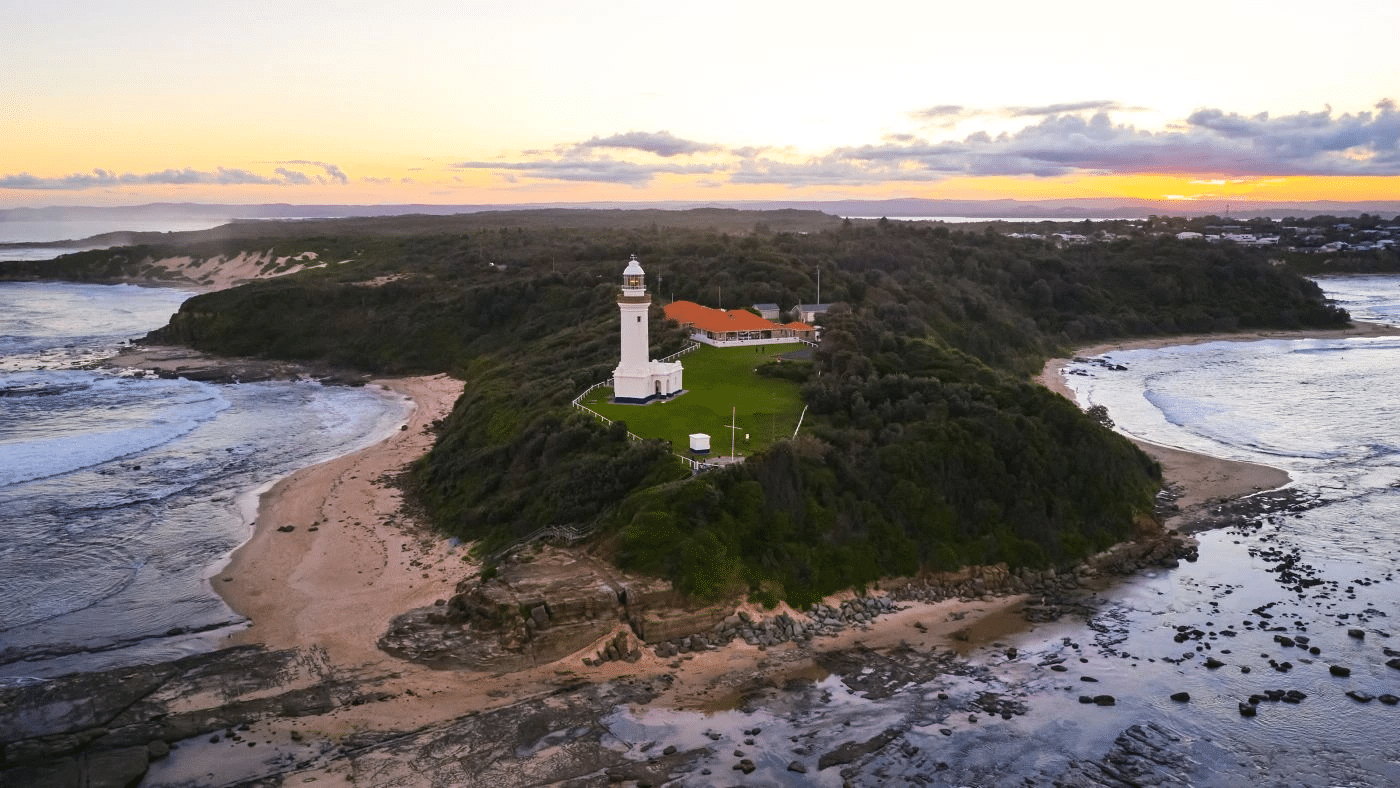 Aerial view of a lighthouse on a small island on the Central Coast
