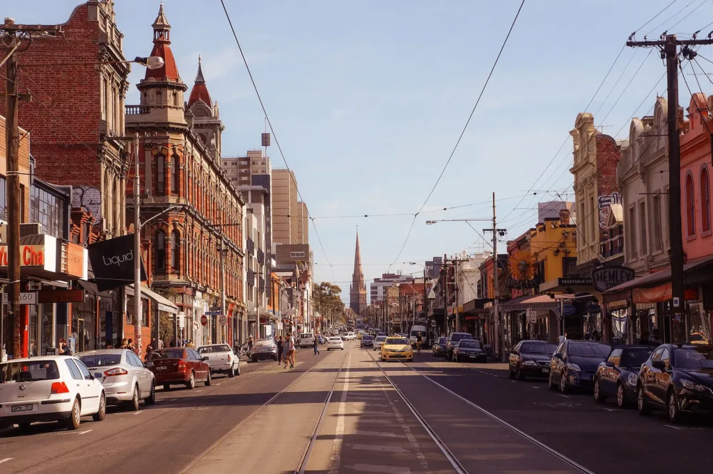 Melbourne city street with parked cars and tall buildings