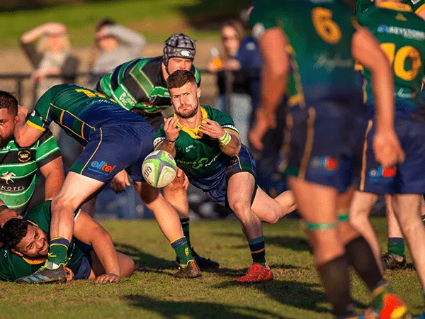 Men playing rugby at a Melbourne stadium
