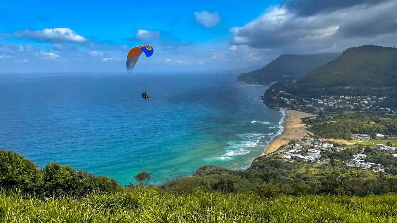 Paraglider over ocean on sunny day in Wollongong