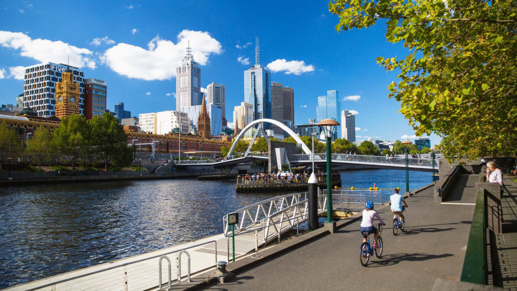 People biking along a riverside street in Melbourne